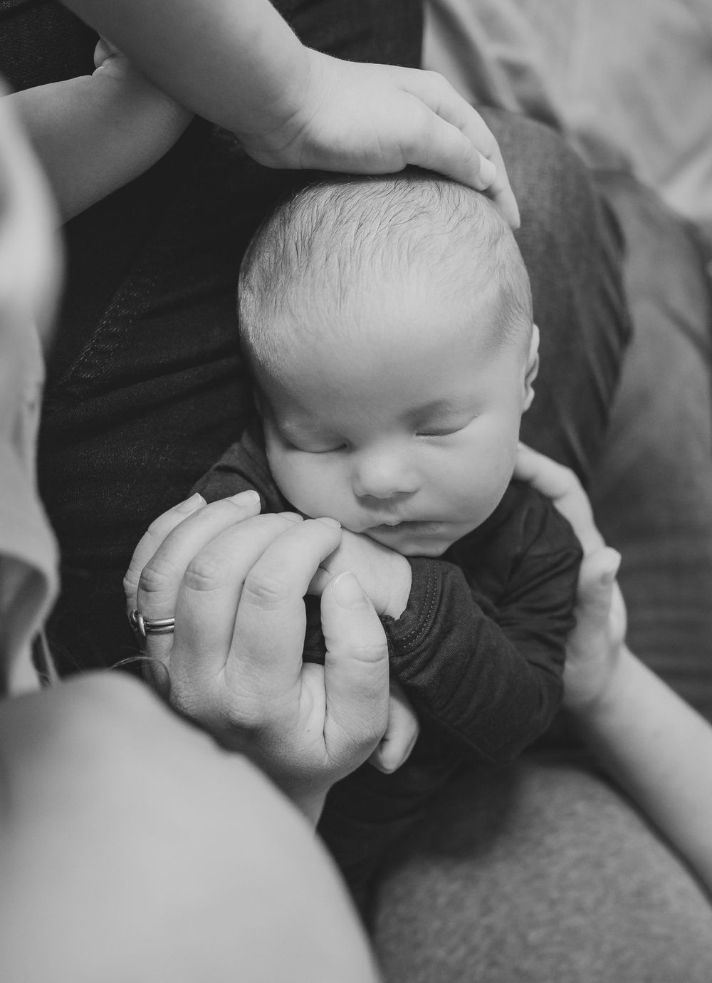 Black and white photo series showing tender moments between parent and child in close-up intimate poses.