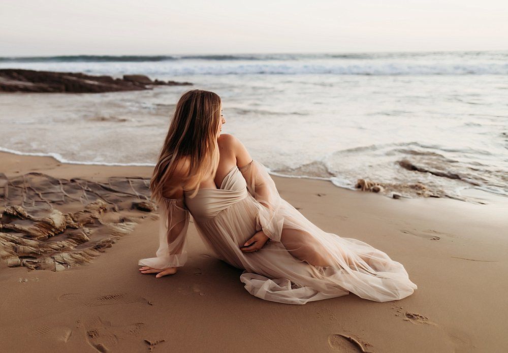 pregnant mama enjoying her maternity photoshoot at the beach