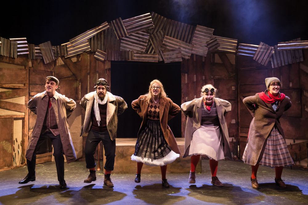 Group dance sequence performed on stage with synchronized movements in period costumes.