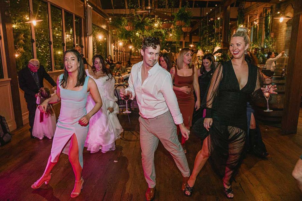 Wedding reception dance floor filled with guests enjoying the celebration.