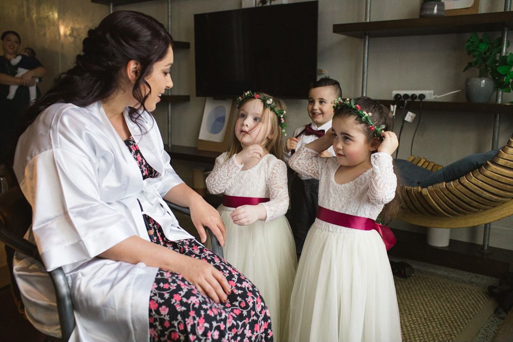 Group preparing for celebration with white dresses and pink accents.