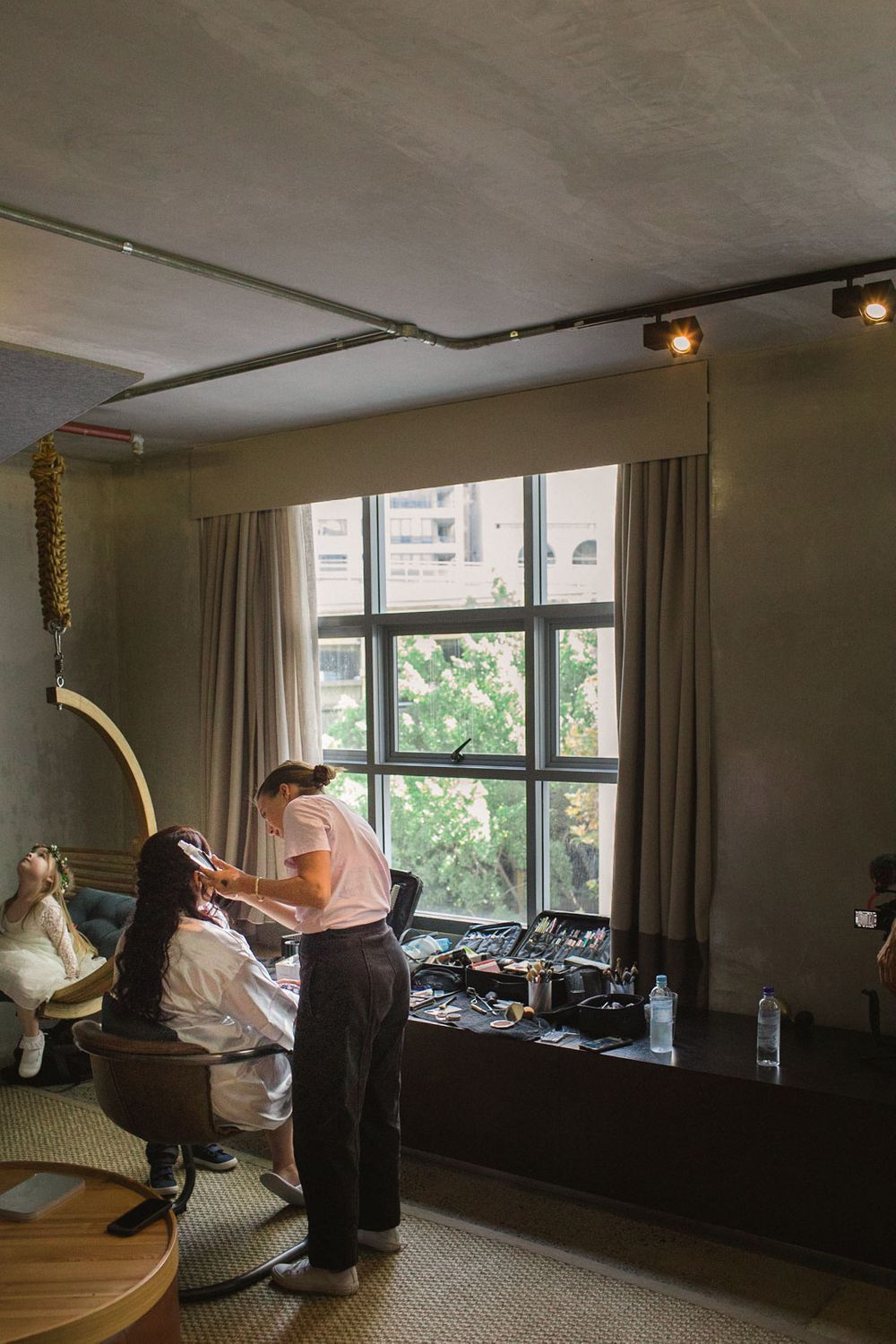 Interior room with large windows and curtains during wedding preparation.