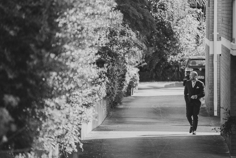 Black and white outdoor walkway with trees lining the path.