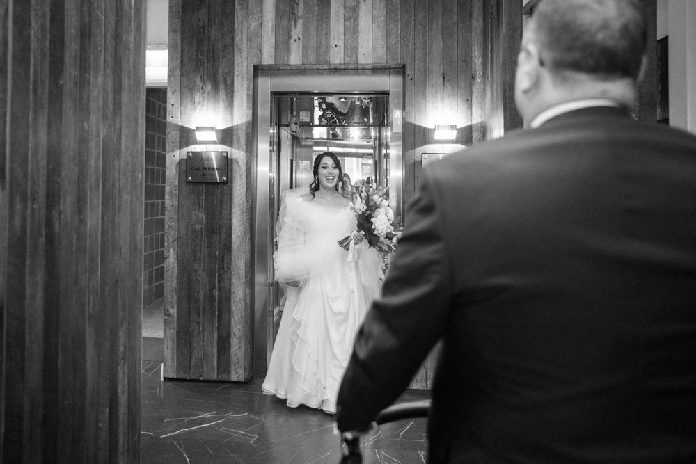 Wedding ceremony moments captured in a wood-paneled venue with dramatic lighting.