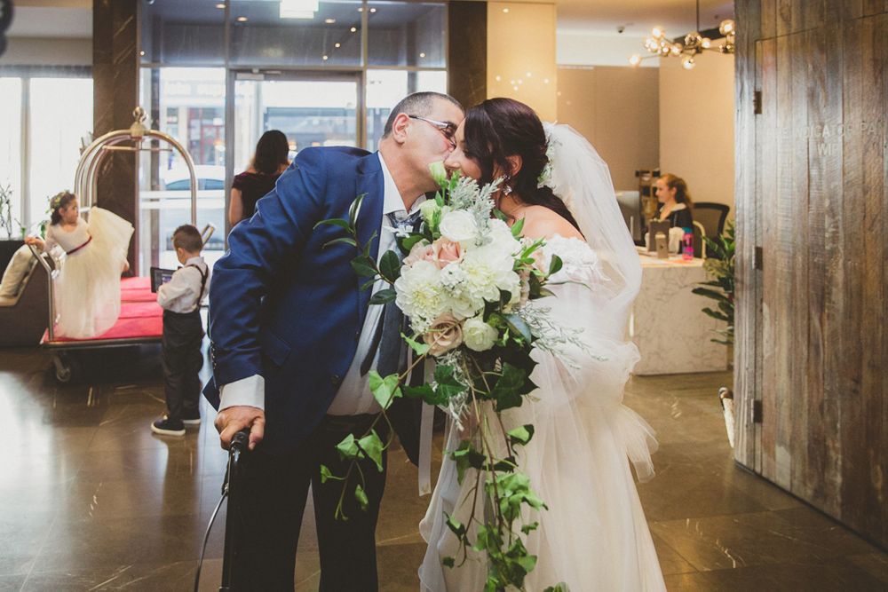 Indoor wedding venue with wooden details and natural light showing reception preparations.