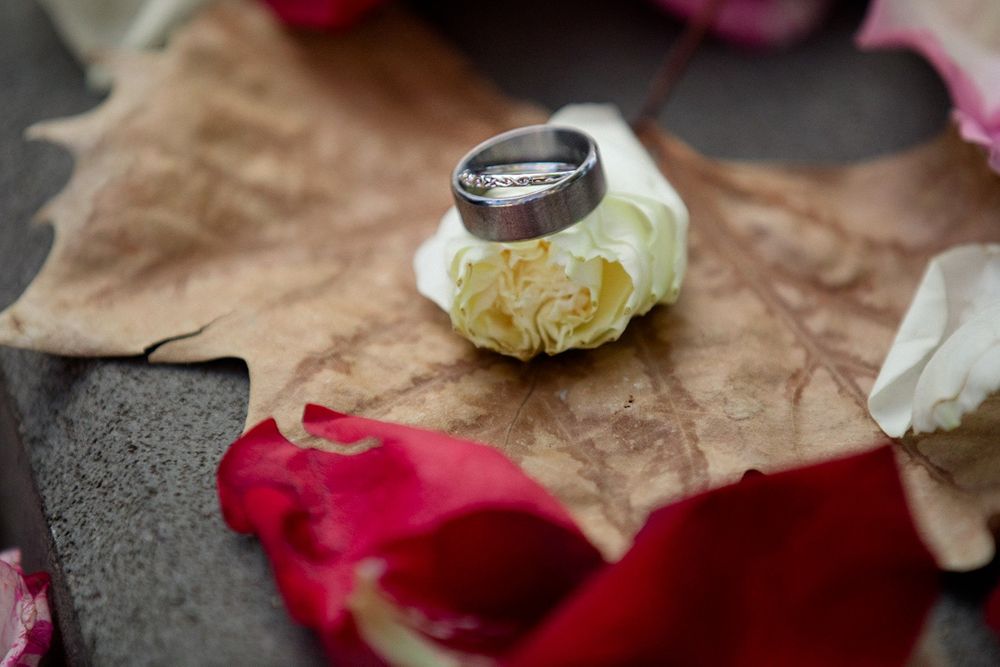 Wedding detail shots of roses and decorative elements on a rustic surface.