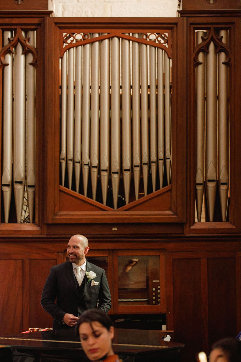 Wooden church organ pipes arranged in an ornate display with decorative woodwork.
