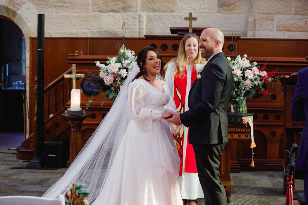 Joyful wedding celebration inside a traditional church with elegant decor and flowers.
