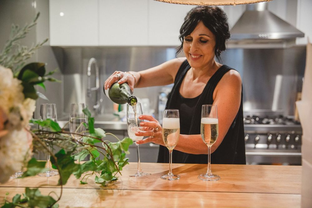 Wedding day preparations captured in a modern kitchen setting with wooden countertops.