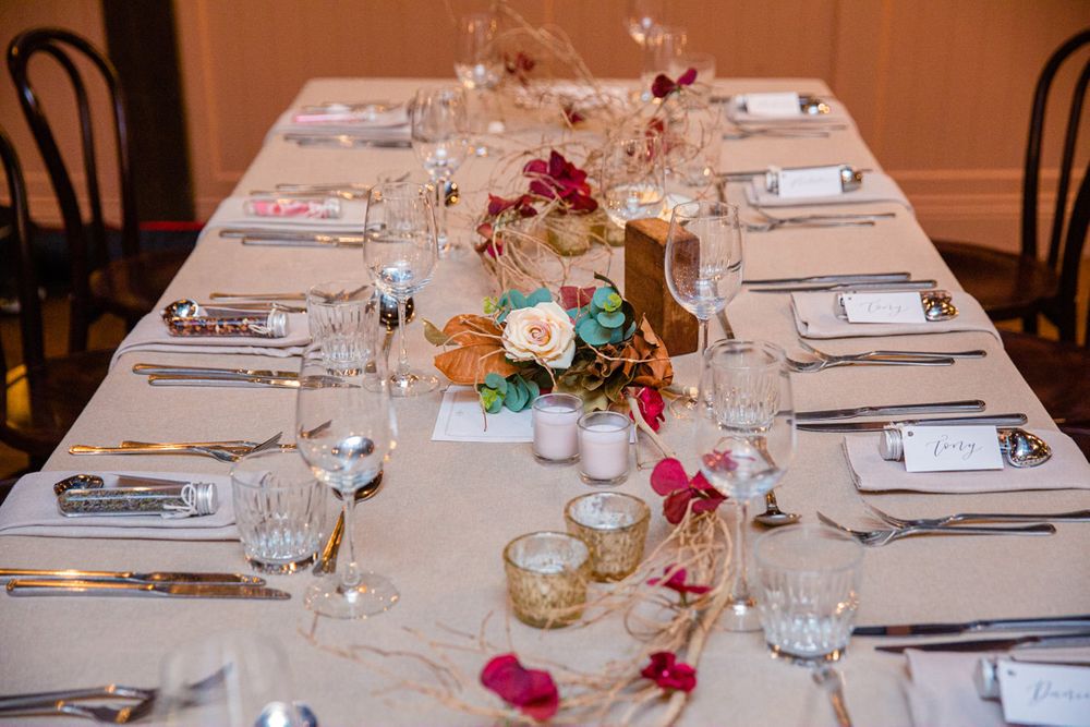 Elegant wedding reception table settings with pink floral centerpieces.
