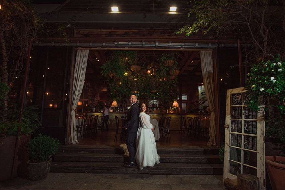 Nighttime wedding venue with illuminated outdoor courtyard and garden spaces.