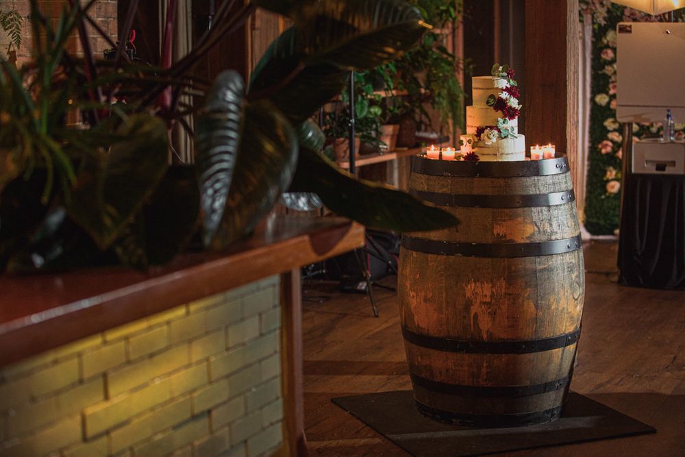 Rustic venue interior featuring wooden barrels and ambient lighting.