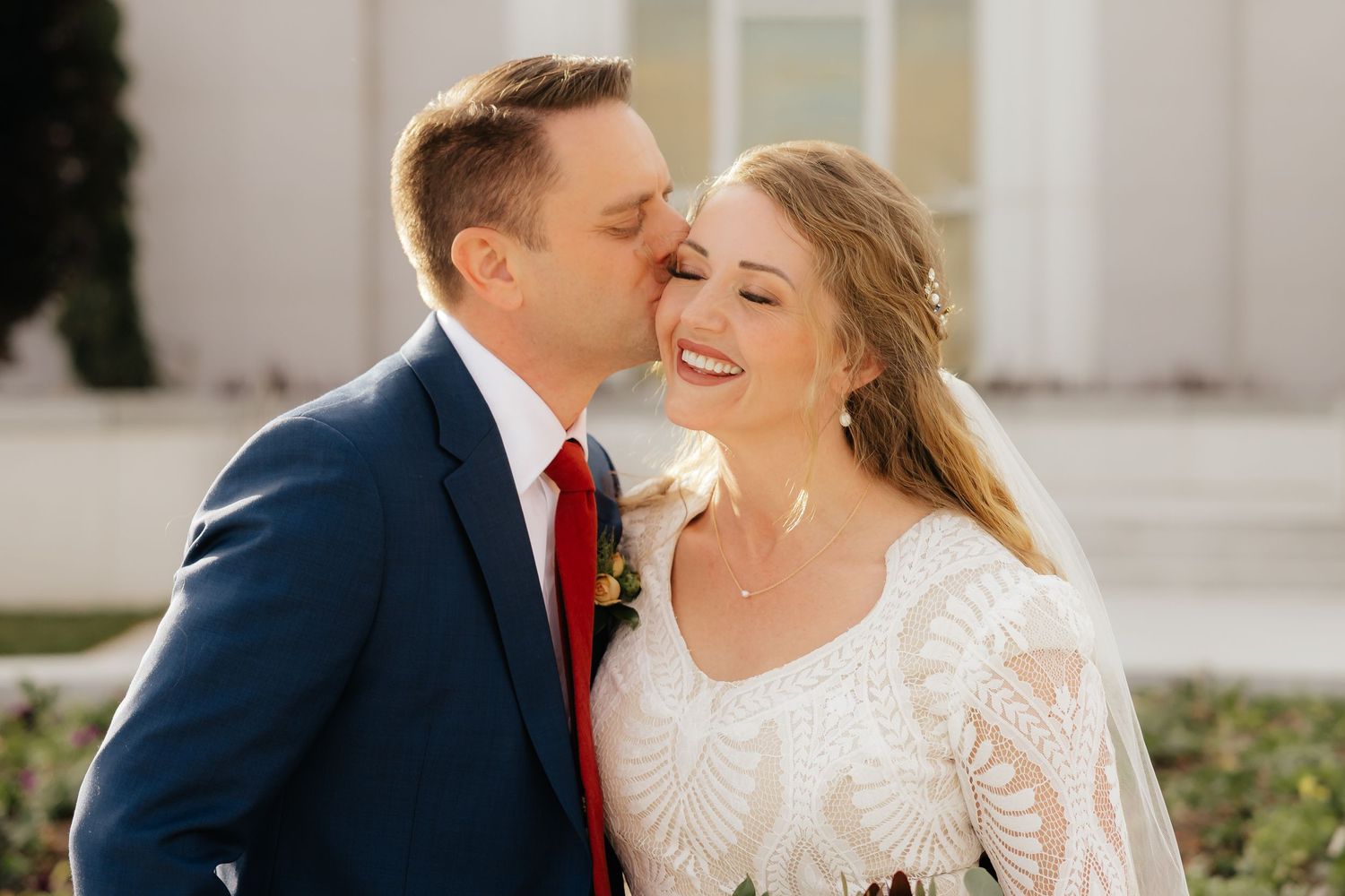 Groom kissing brides cheek