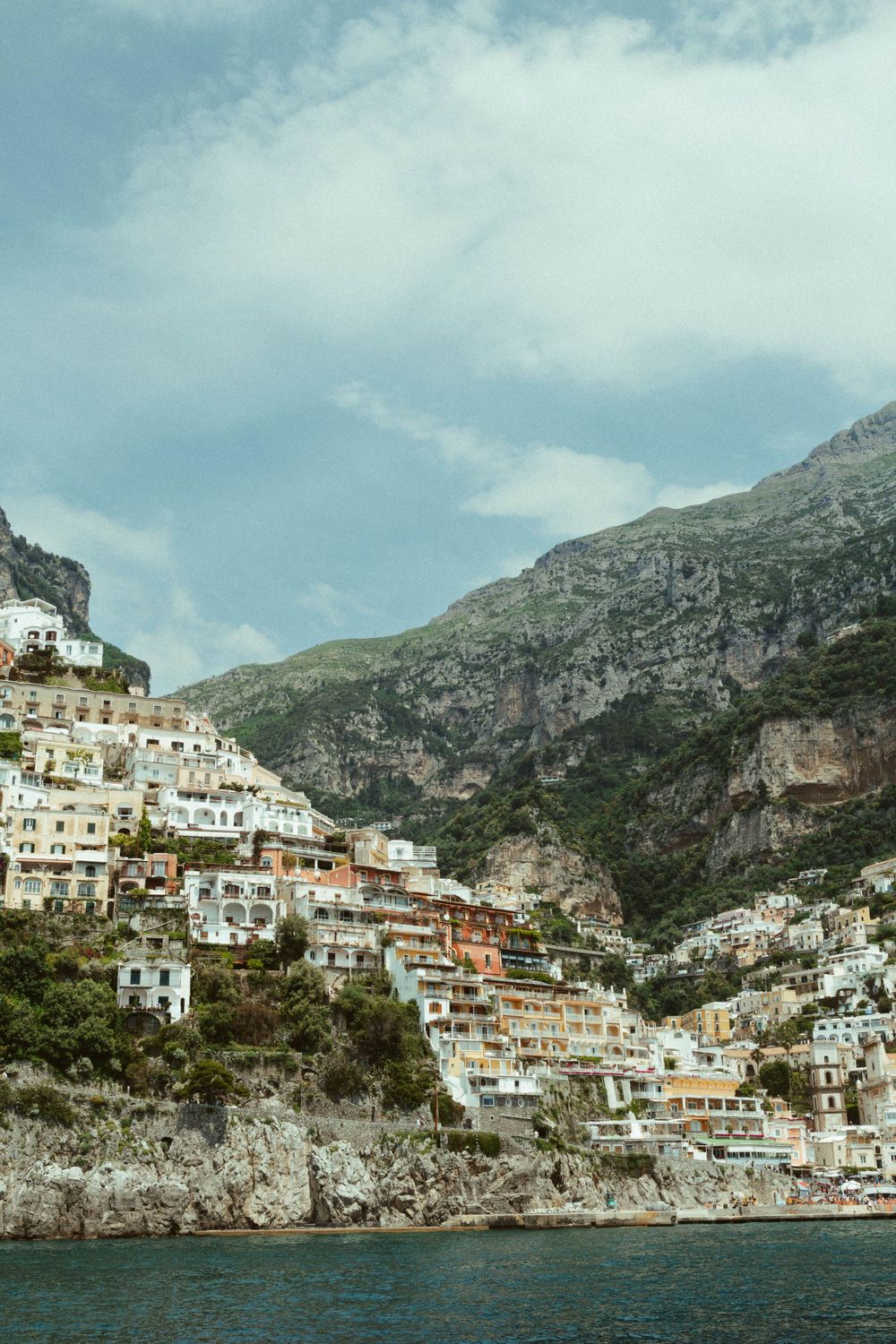 Colorful hillside houses of Positano cascade down steep cliffs along Italy's Amalfi Coast.