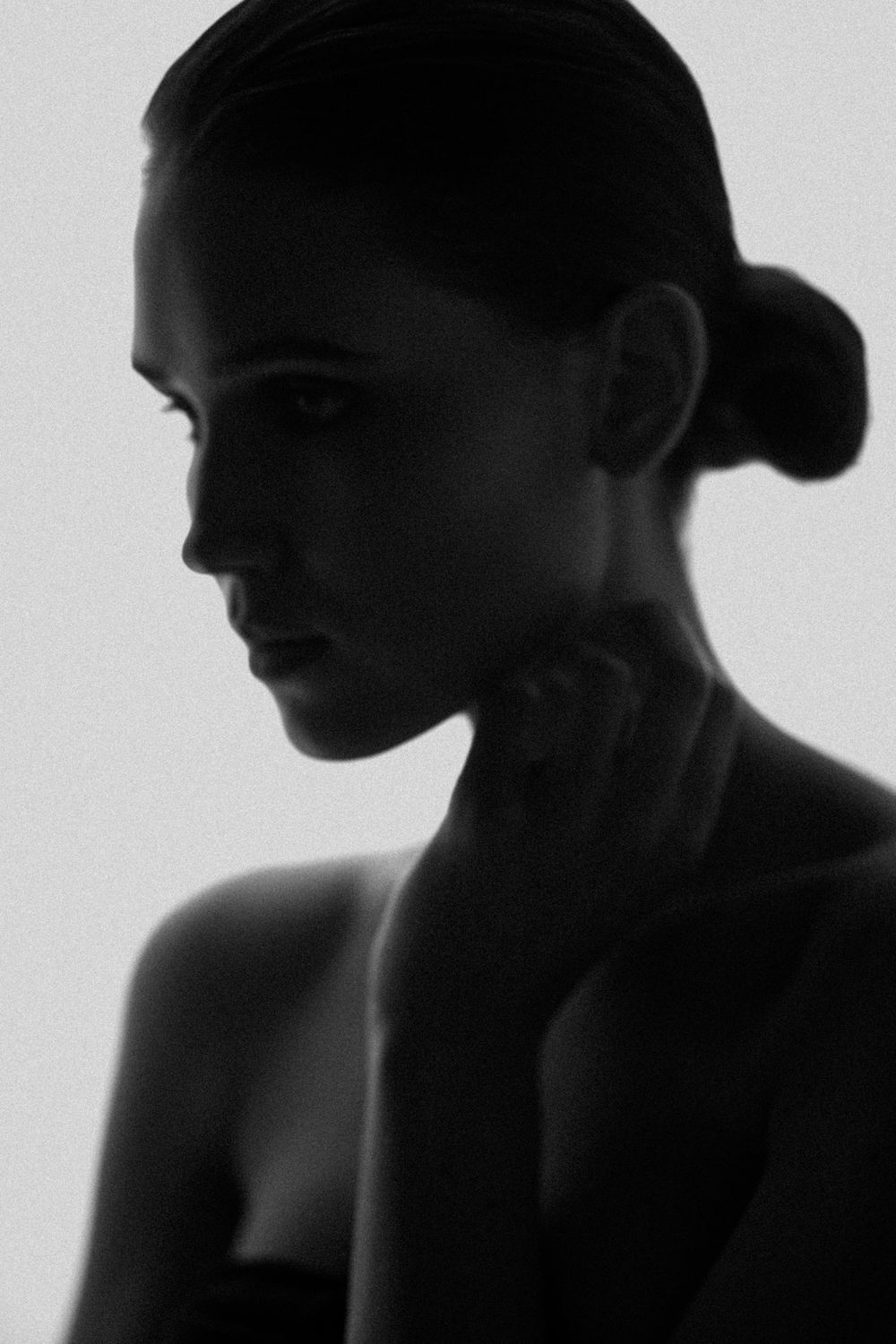 Dramatic black and white silhouette portrait with strong shadows and minimalist aesthetic.