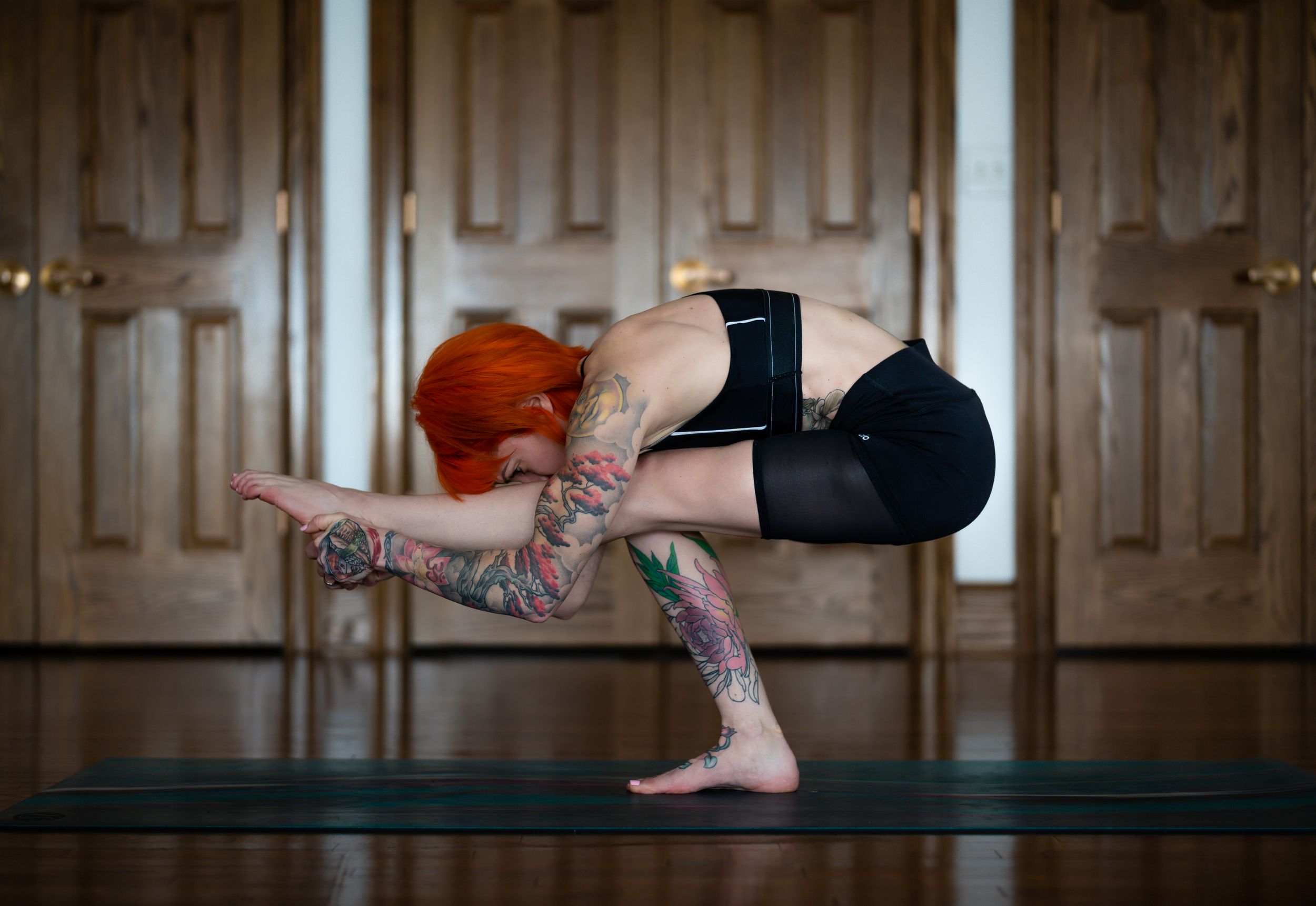 Progressive yoga headstand poses demonstrated against wooden paneled wall.