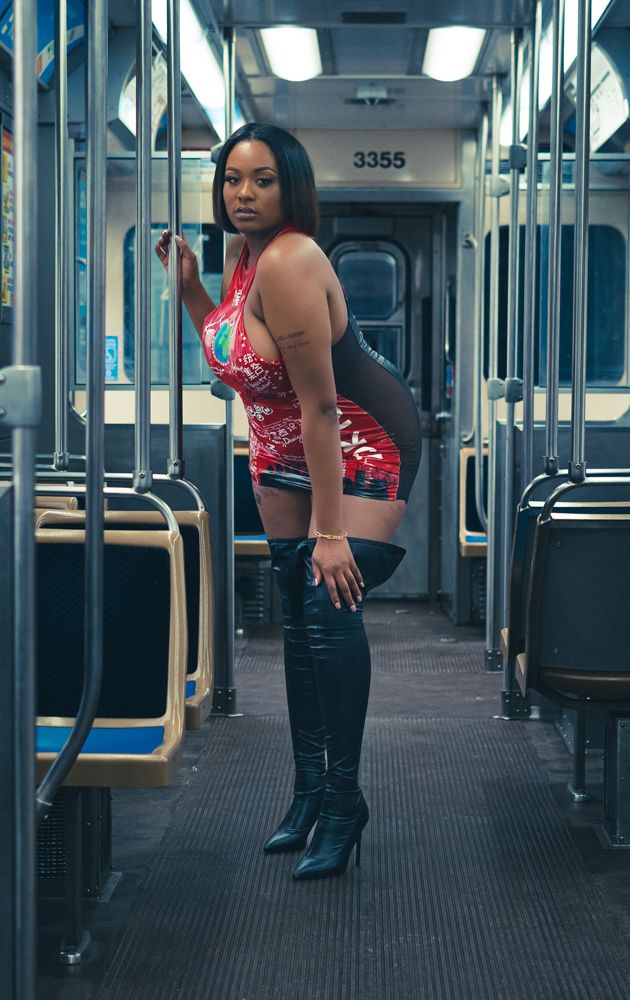 Dance-like poses captured in an empty subway car with red top and black pants.