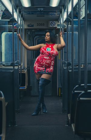 Dancer performing expressive moves in empty subway car.