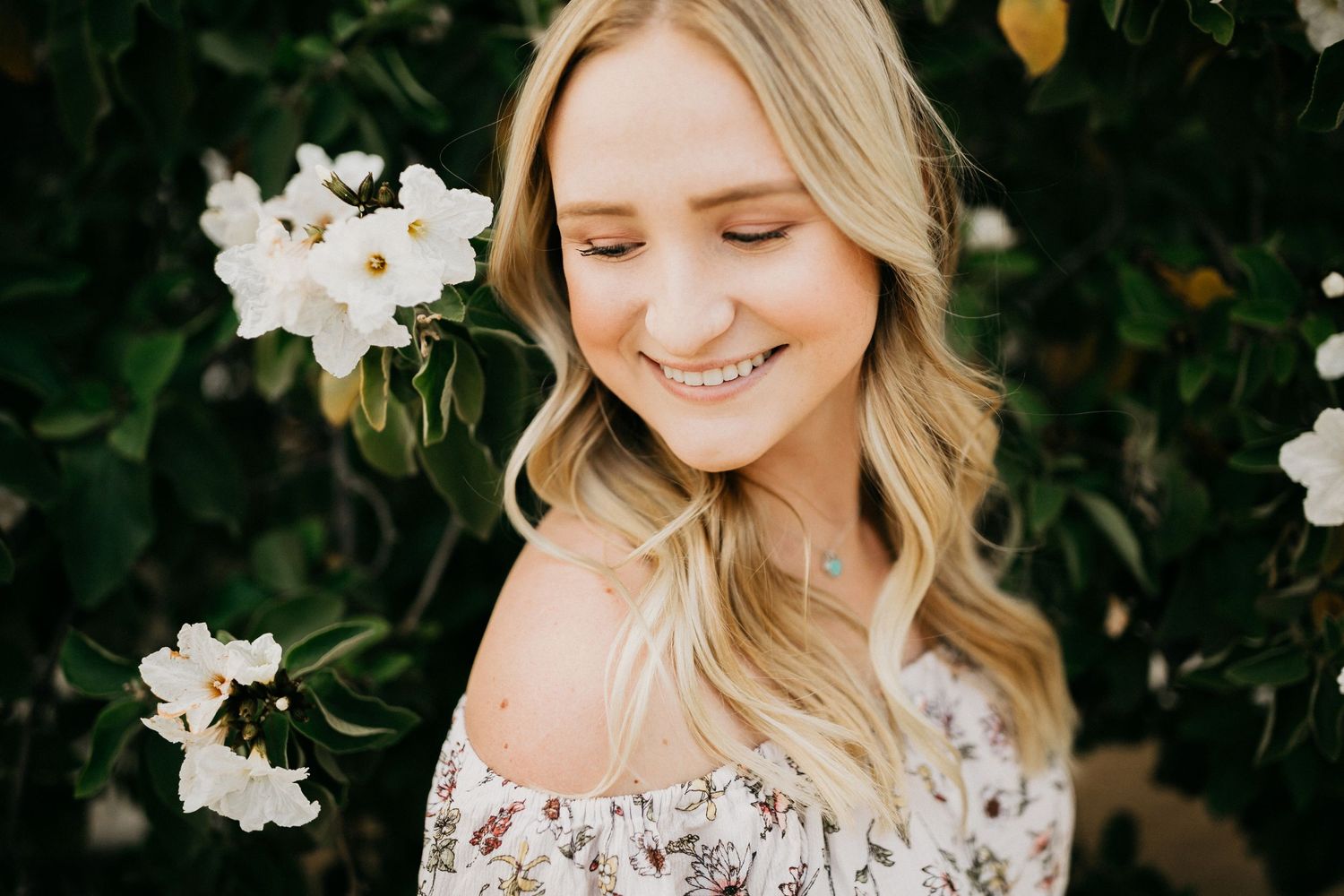 Portrait with white orchids and natural greenery backdrop.