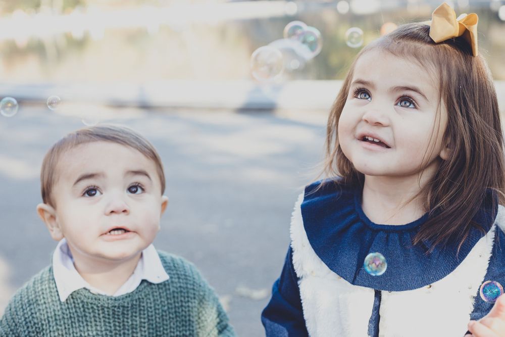 Portrait series of a child in blue dress against autumn background.