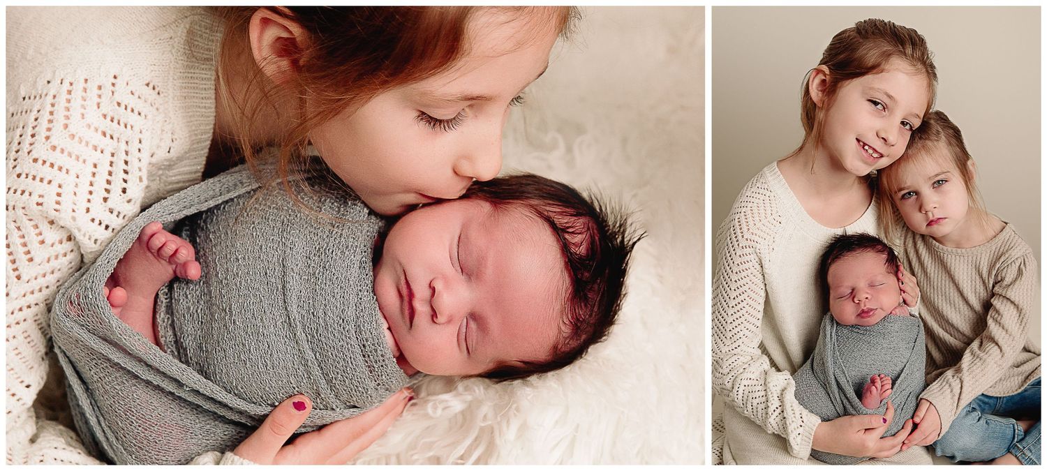 girl kissing newborn boy on the cheek