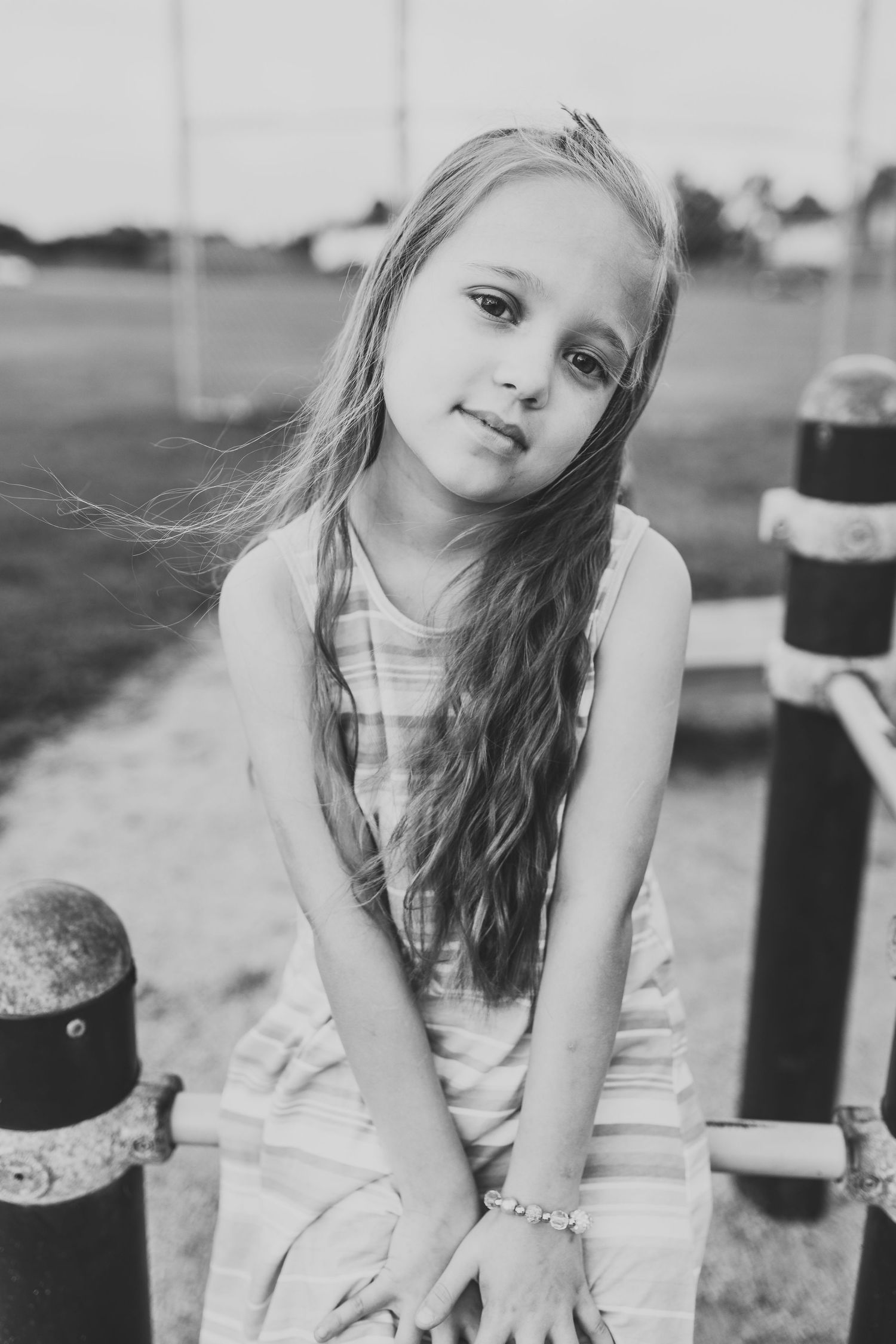 Black and white portrait in an outdoor setting.