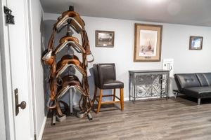 Furnished basement room with leather furniture and rustic wooden decor.