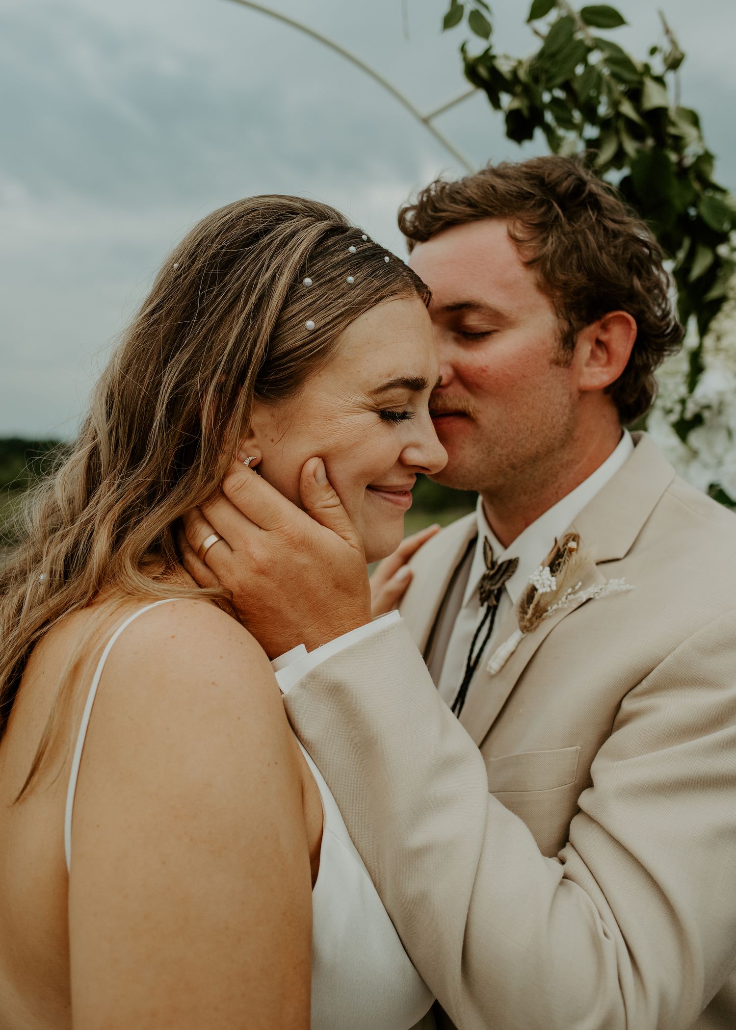 Intimate wedding moment captured during golden hour outdoors.
