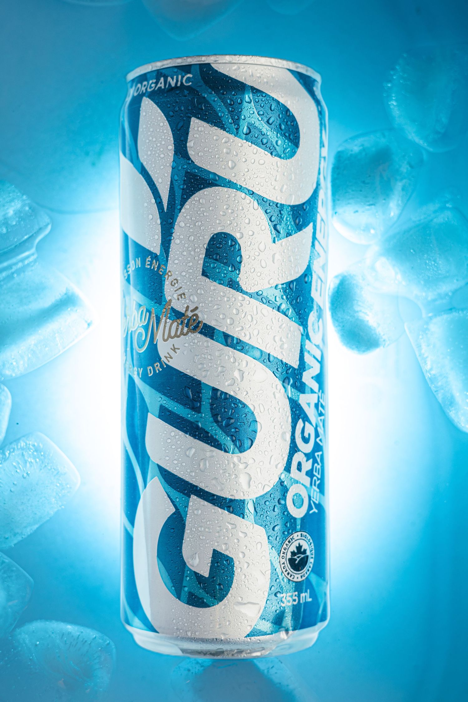 Chilled can of Guru Original energy drink with condensation against blue background.