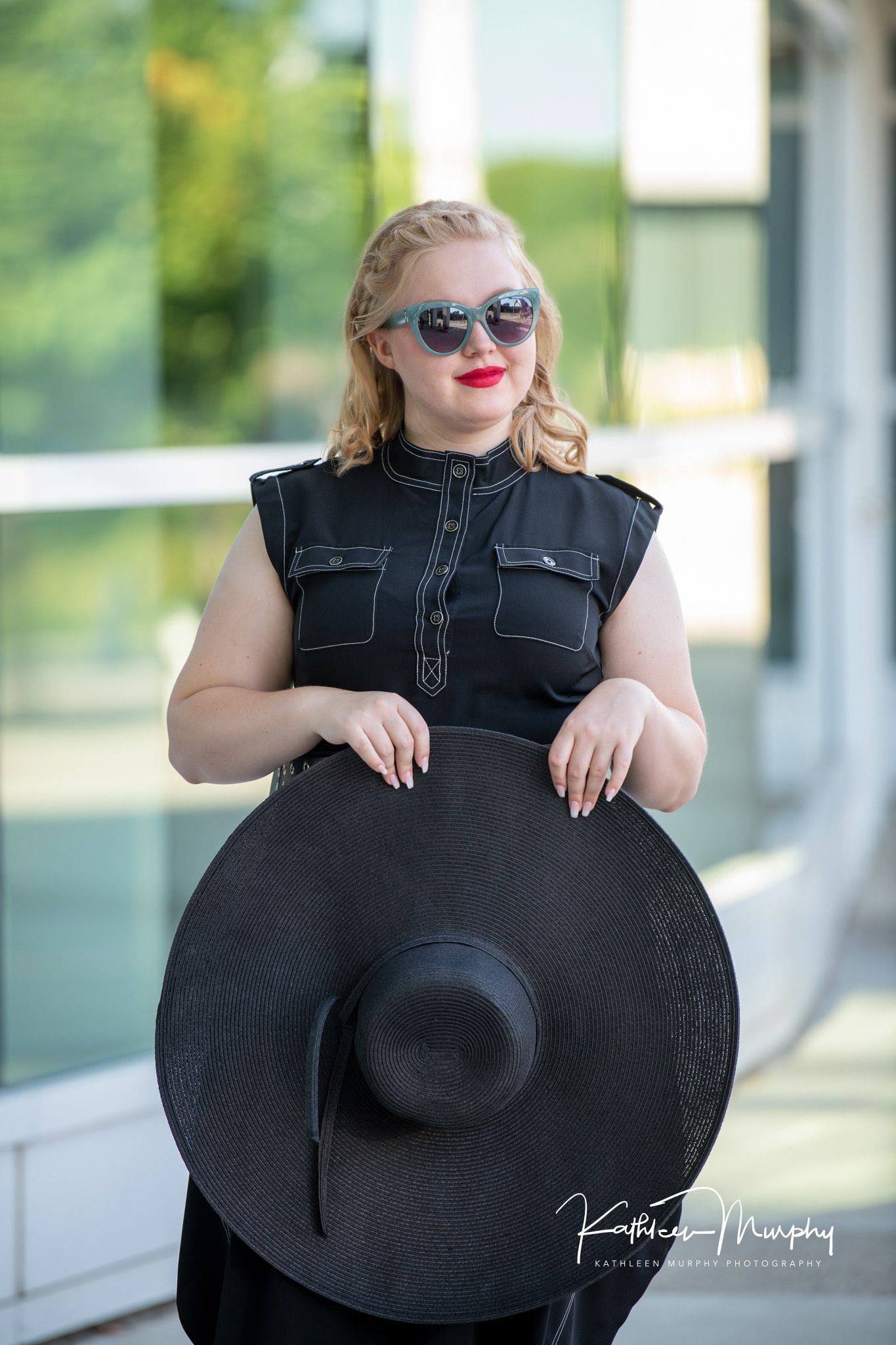 Kathleen Murphy Photography picture of a girl in a black dress with a black floppy hat and sunglasses