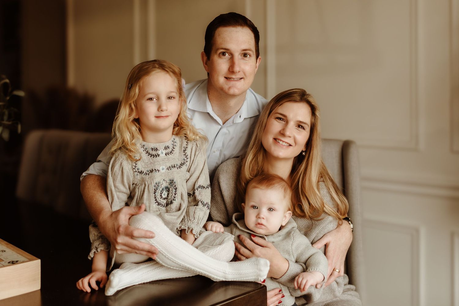 A warm family photoshoot session in an elegant interior setting.