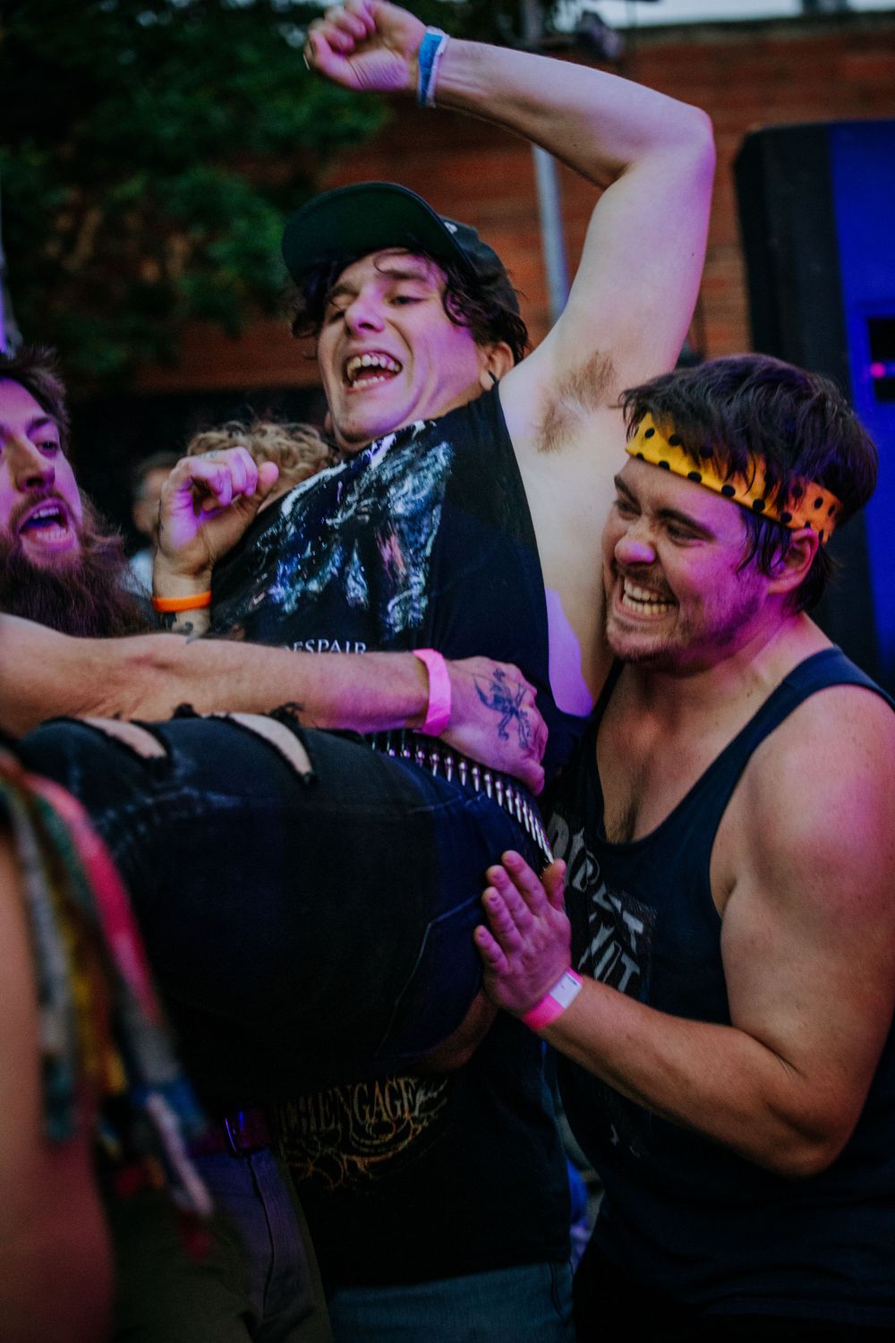 Concert crowd lifting and celebrating during an energetic live music performance.