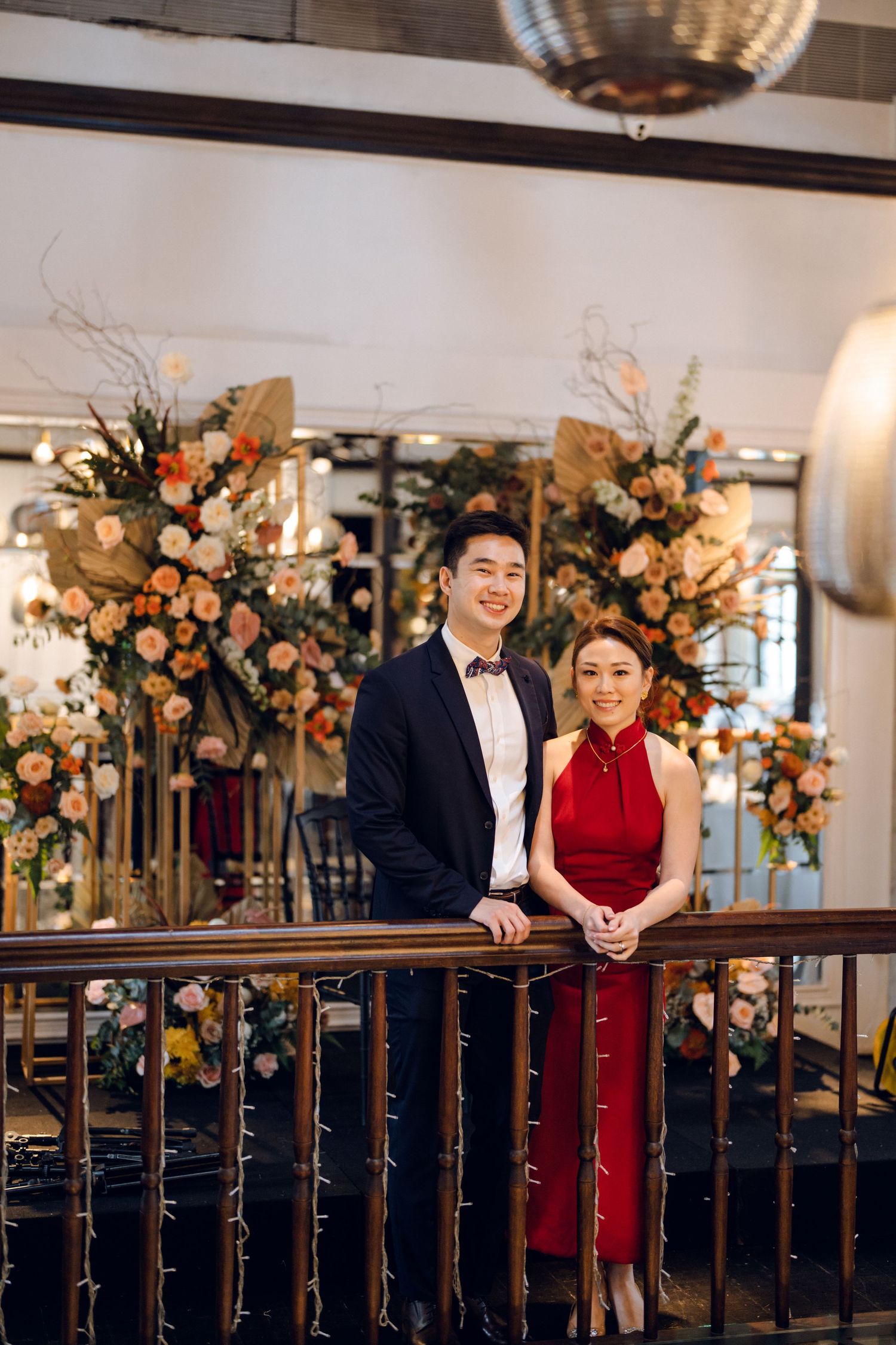 Elegant wedding venue with floral arch and decorative staircase railing.