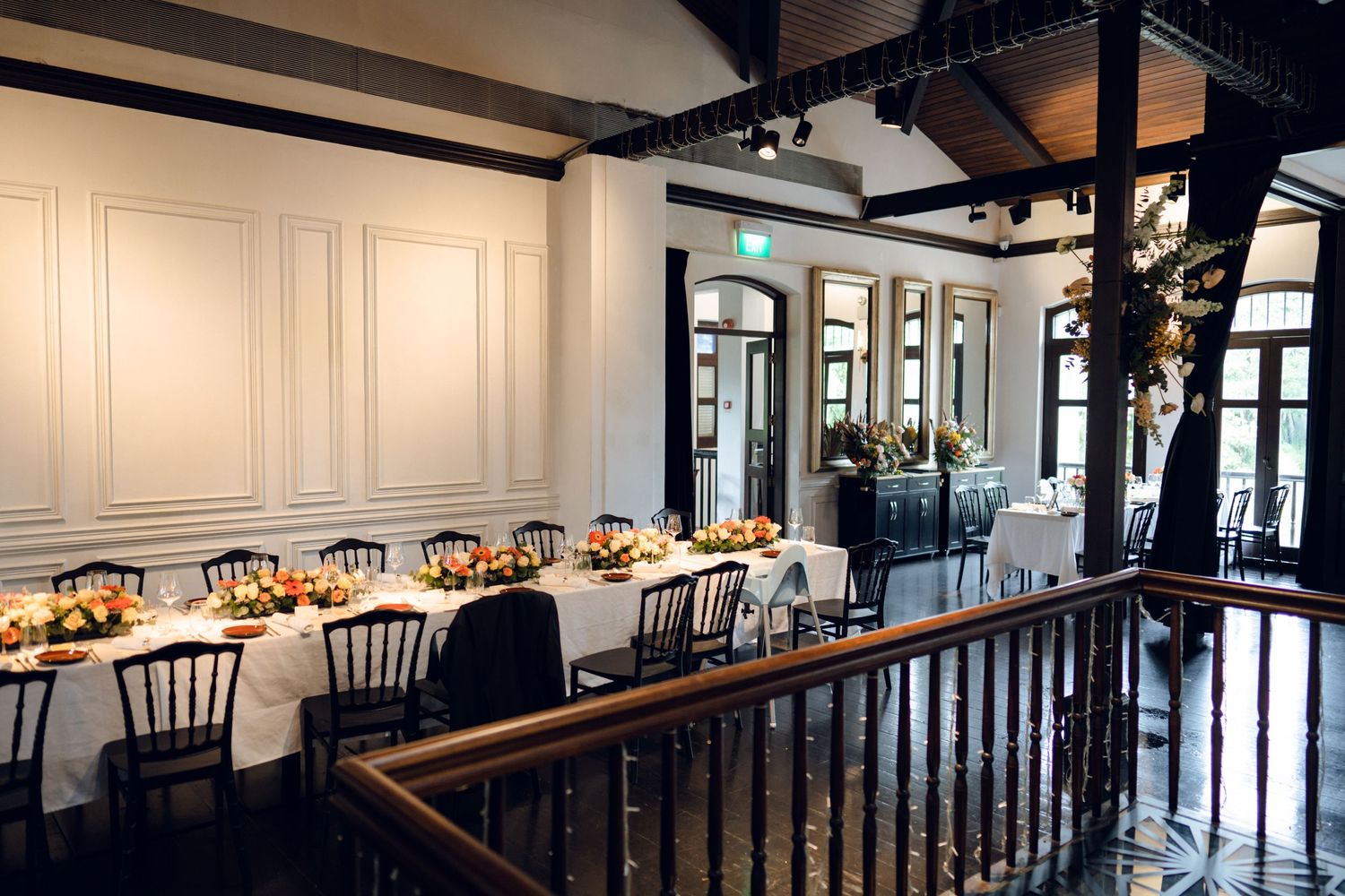 Modern wedding venue interior showcases white paneled walls and dark wood accents.
