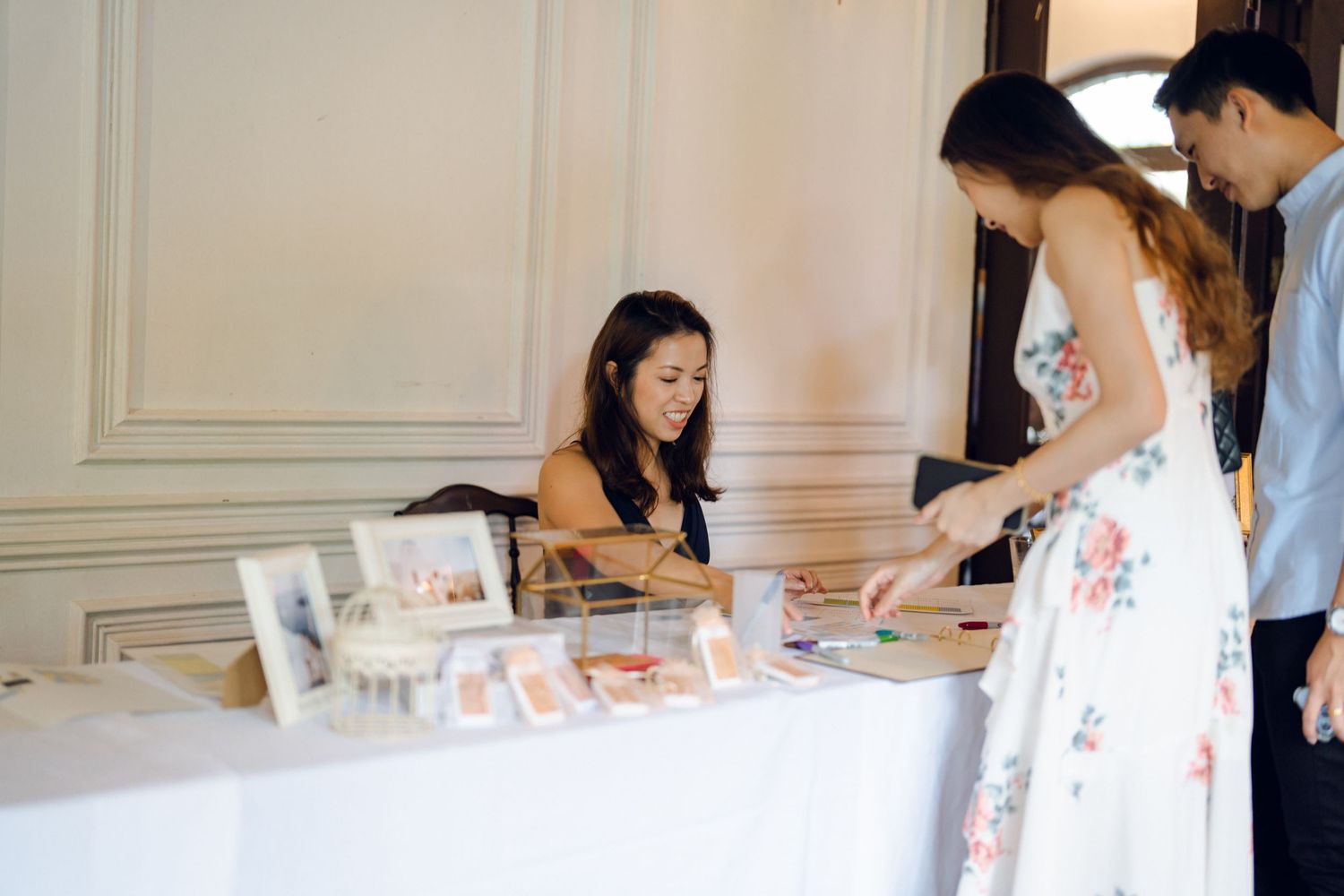 Wedding guests gathered around a table during a celebration event.