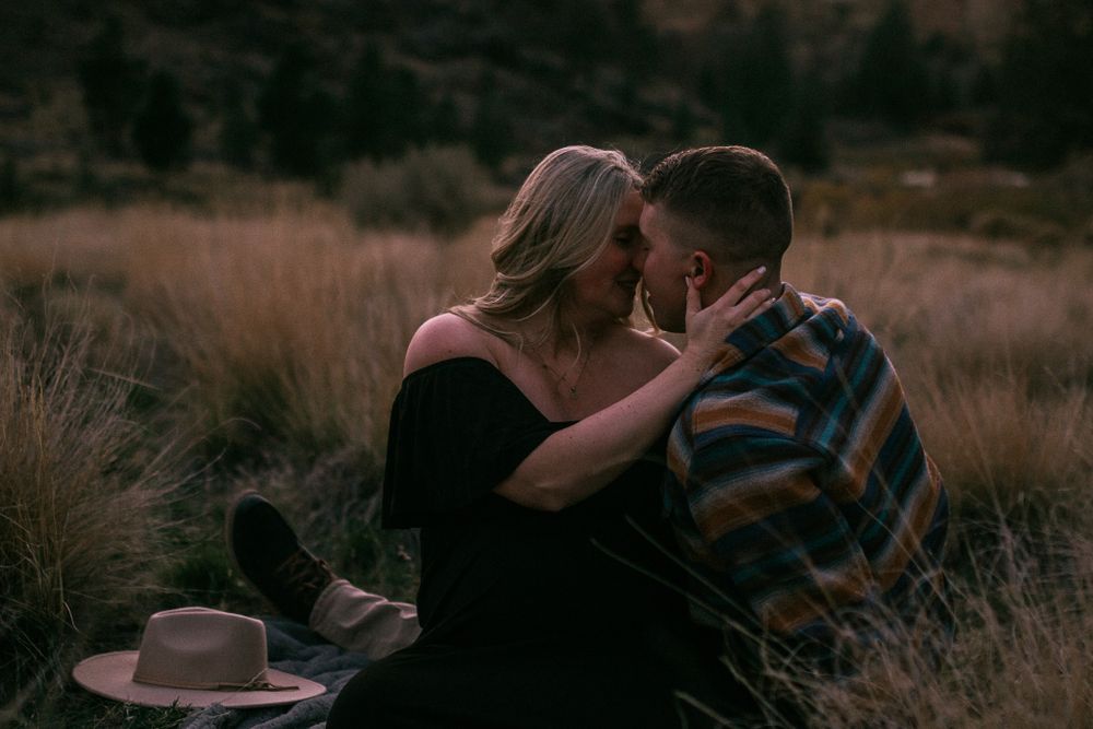 A romantic sunset moment in a desert landscape with a discarded hat in the foreground.