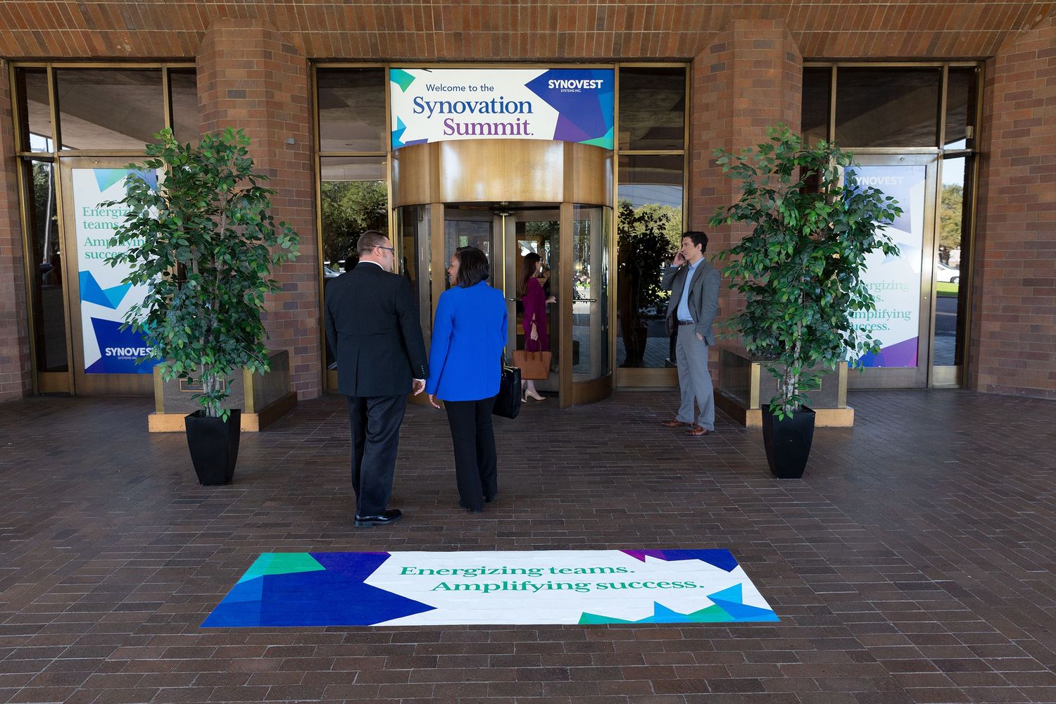 Large conference graphics and signage printed by FedEx Office are seen at the entrance of a hotel and convention center.