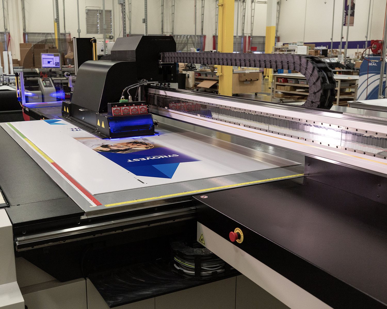 A large format printer at a FedEx Office Commercial Printing Center creates large graphics for a convention.