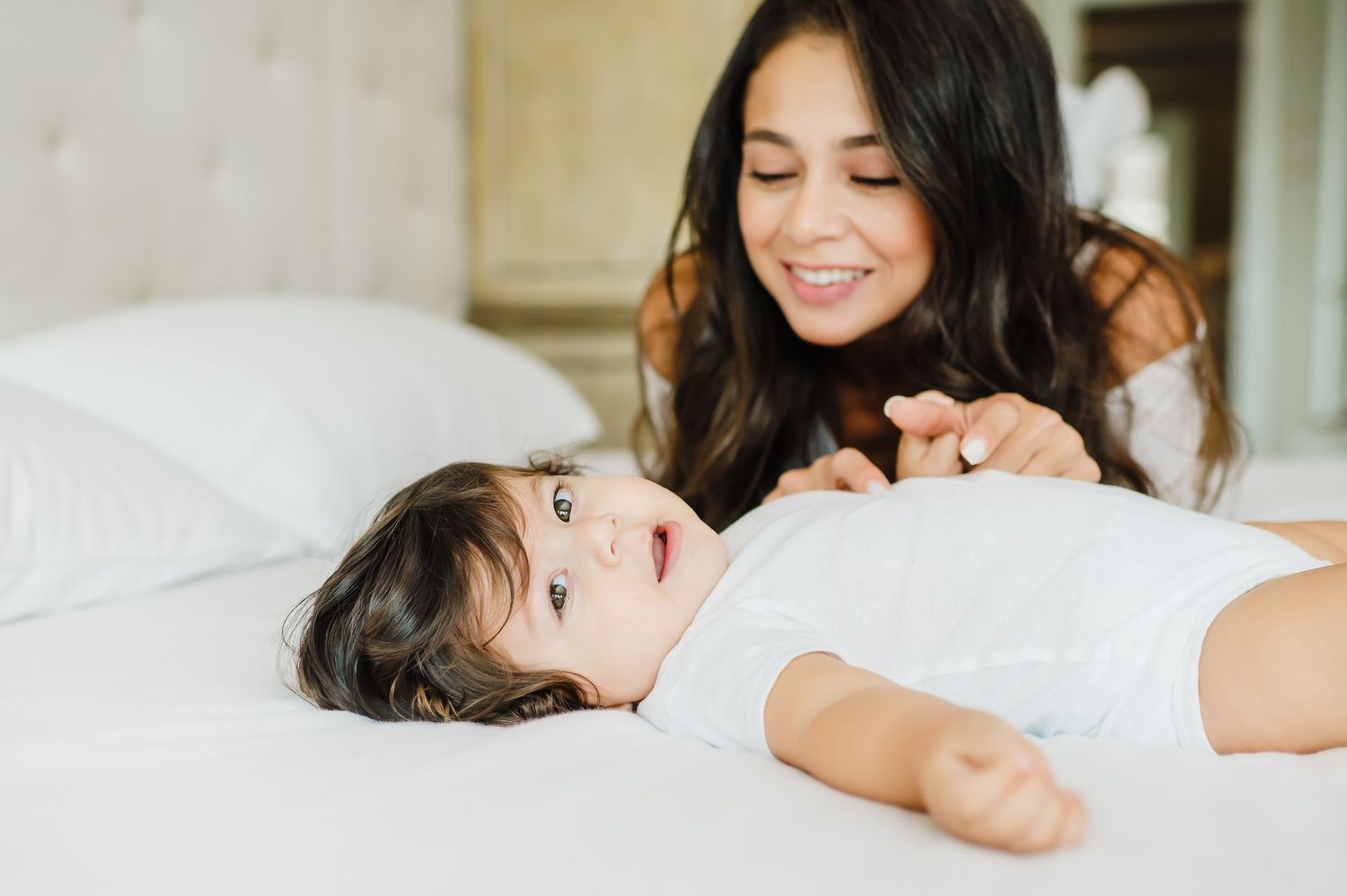 Intimate lifestyle photos on white bedding with natural morning light.