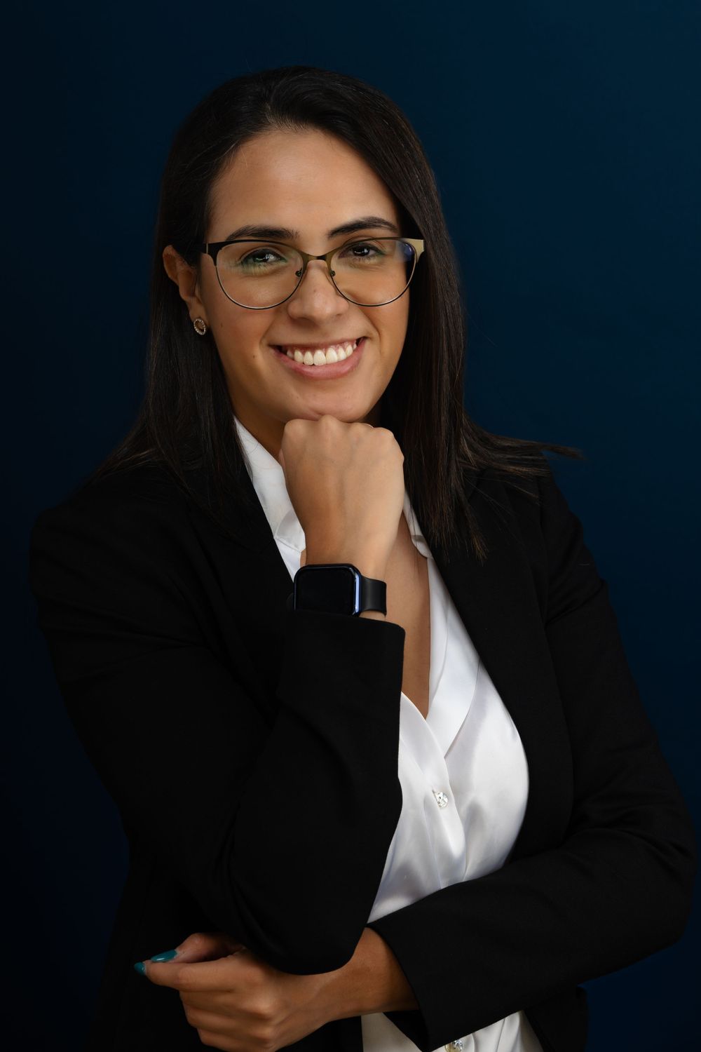Corporate headshot series showing professional poses against deep blue background.