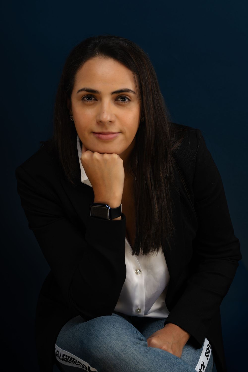 Professional headshots against dark blue background showing contemplative expressions.