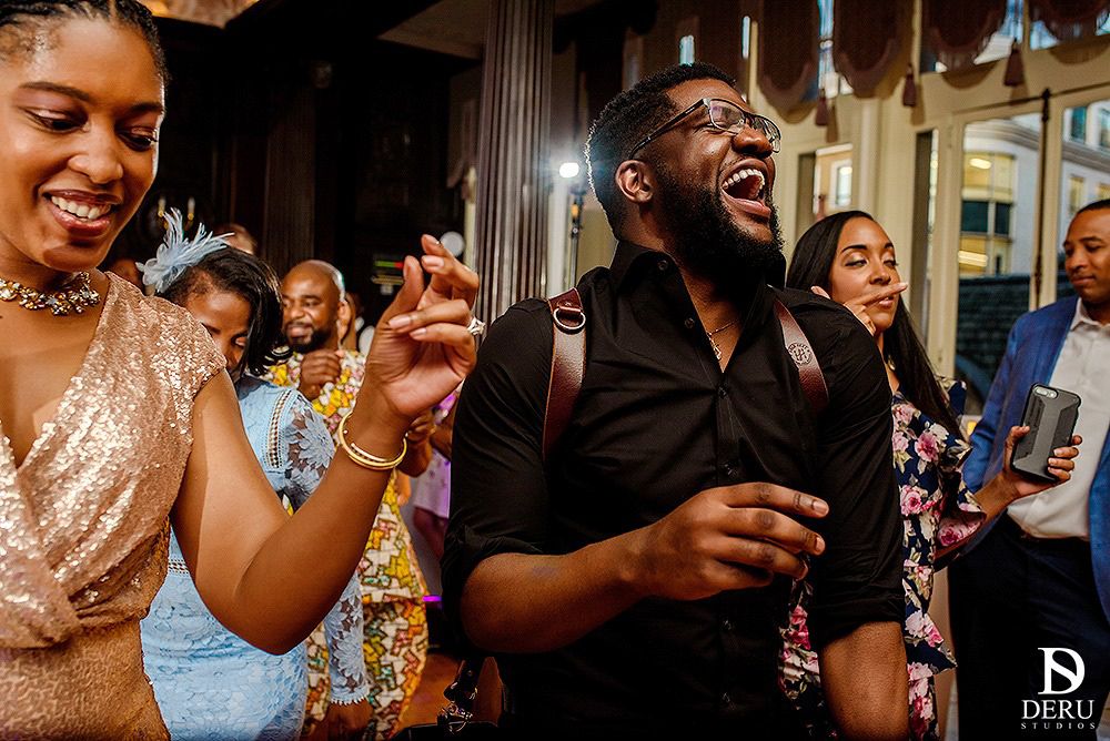 Wedding reception guests dancing and celebrating with energy and joy.