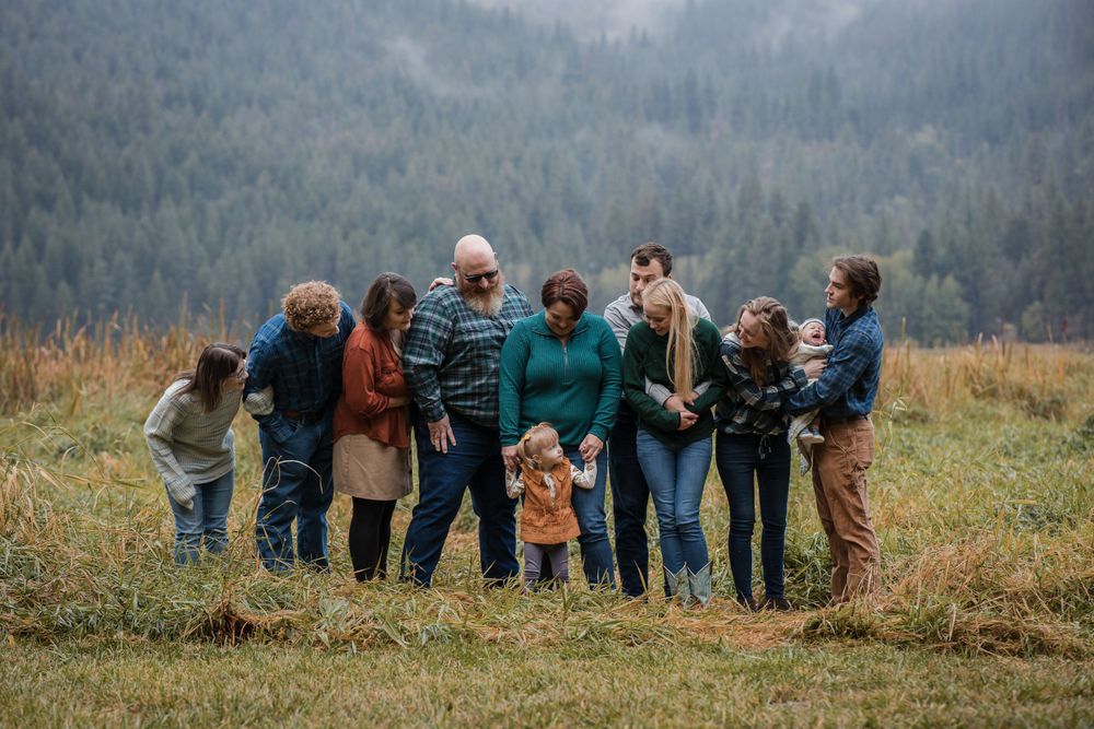 Family portrait at Liberty Lake Regional Park, surrounded by stunning mountain scenery.