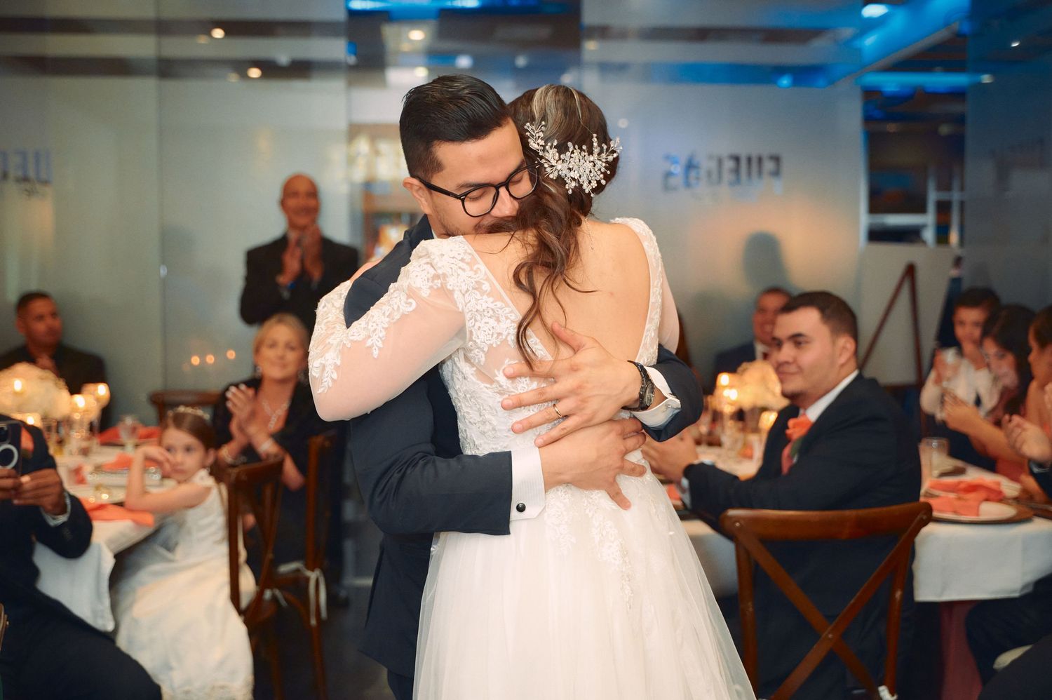 Intimate first dance moment at wedding reception with guests watching.