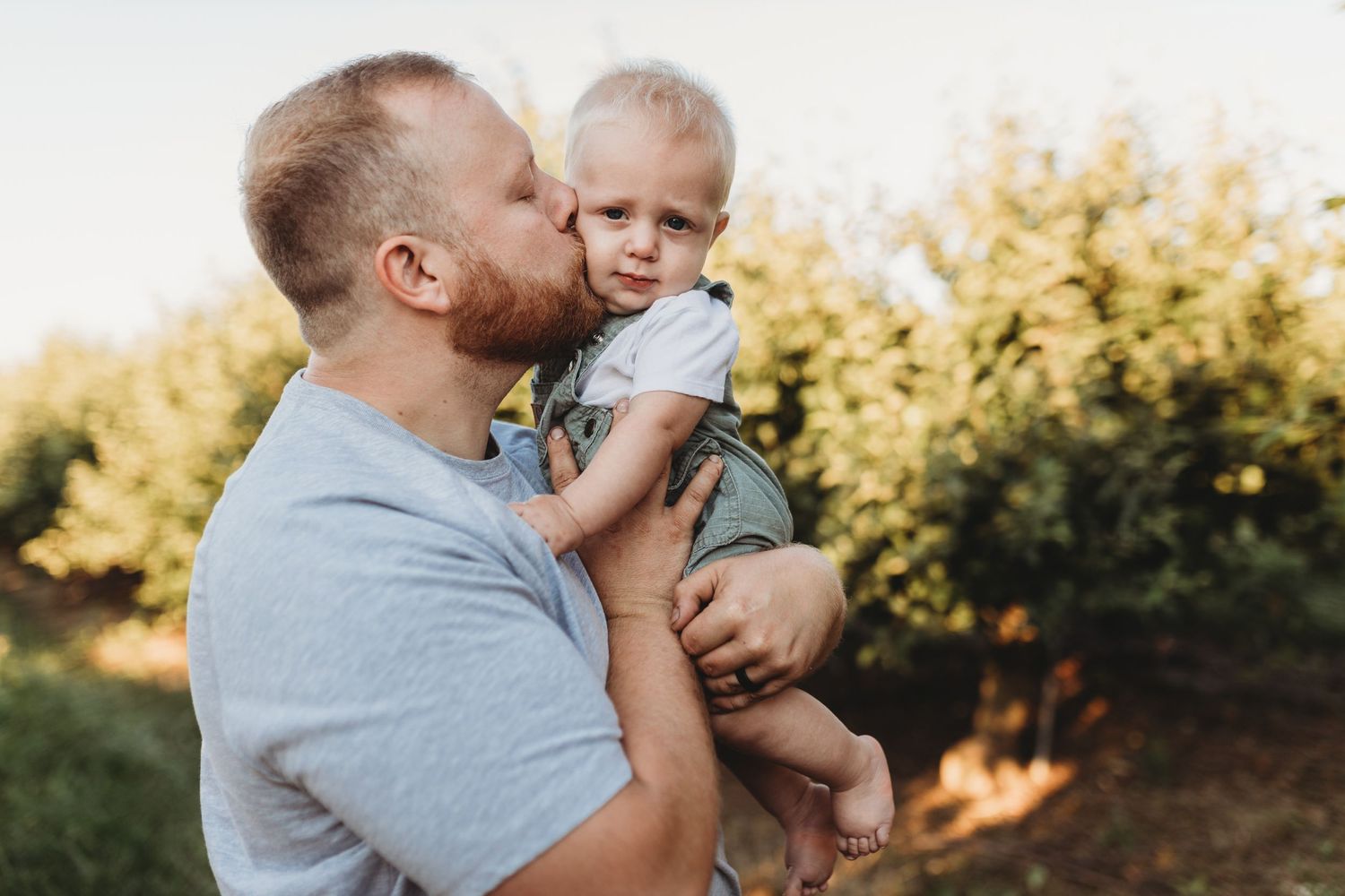 A father gives his small son a kiss on the cheek in Lancaster, Pennsylvania