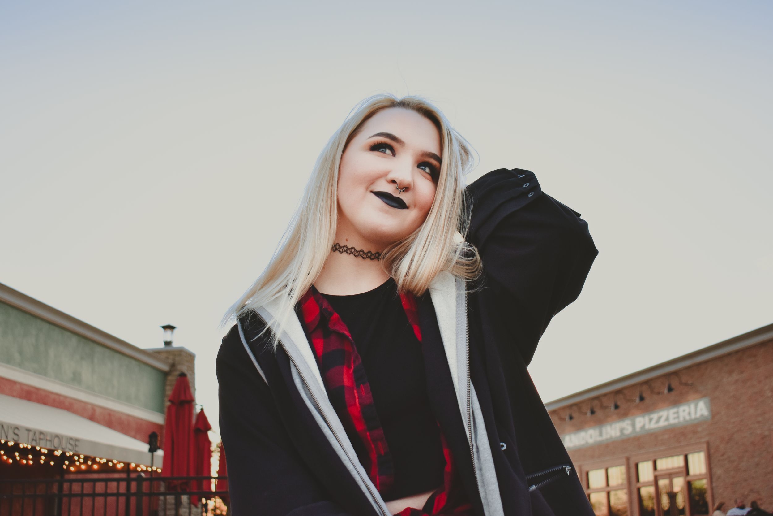 A young woman showcases her alt fashion in a senior photo shoot