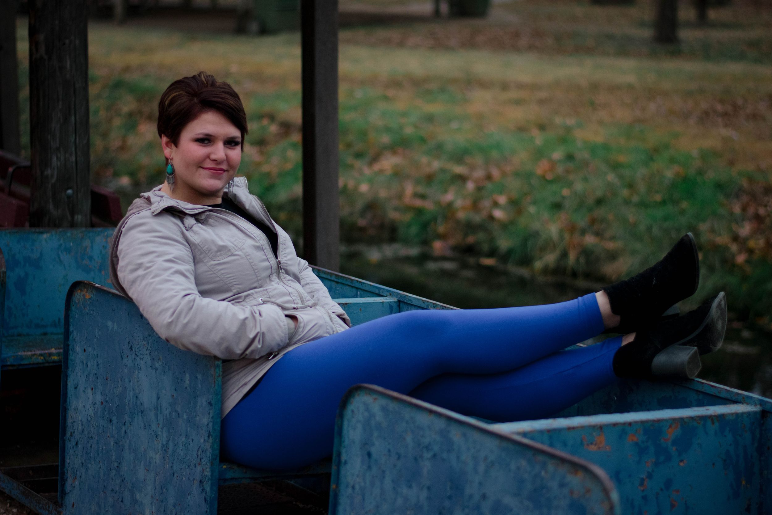 A young woman with bright blue pants poses in Ada, Oklahoma
