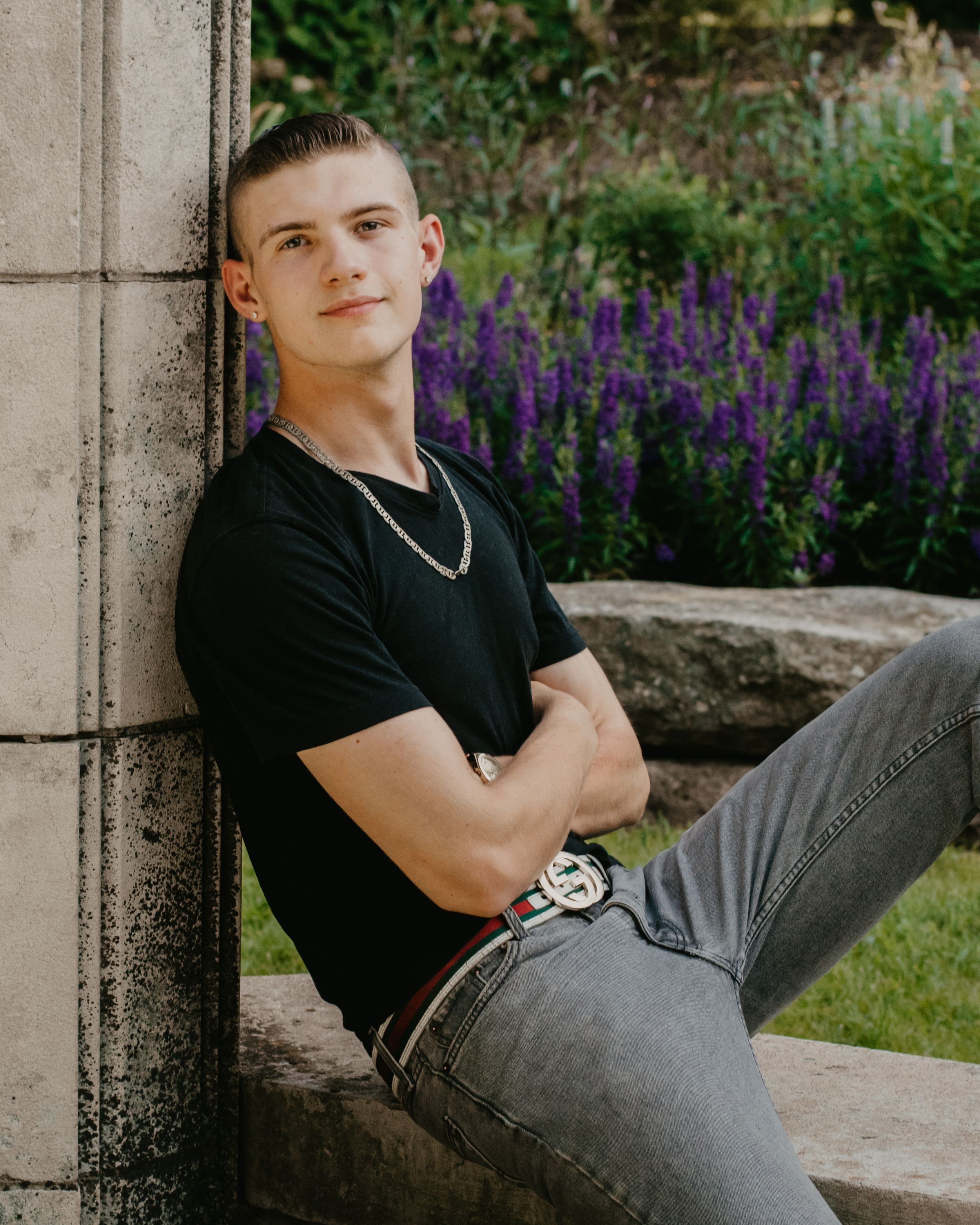 A young man shows off his trendy outfit for his senior photos