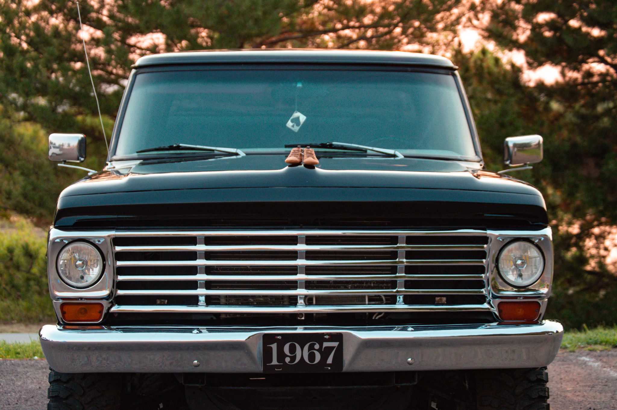 Front view of a classic dark green 1967 vintage truck with chrome grille.
