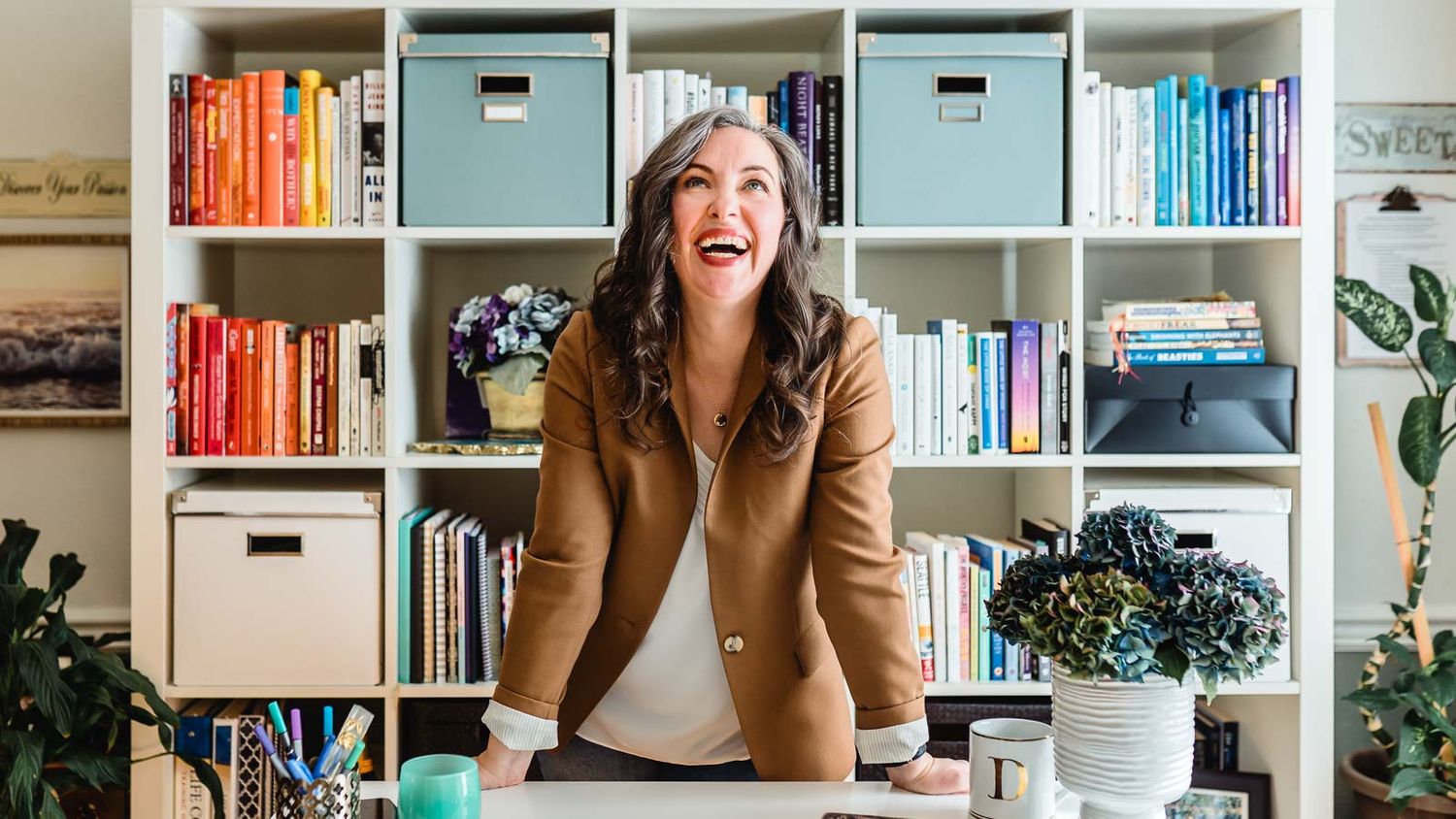 life and mindset coach smiling happily standing at desk